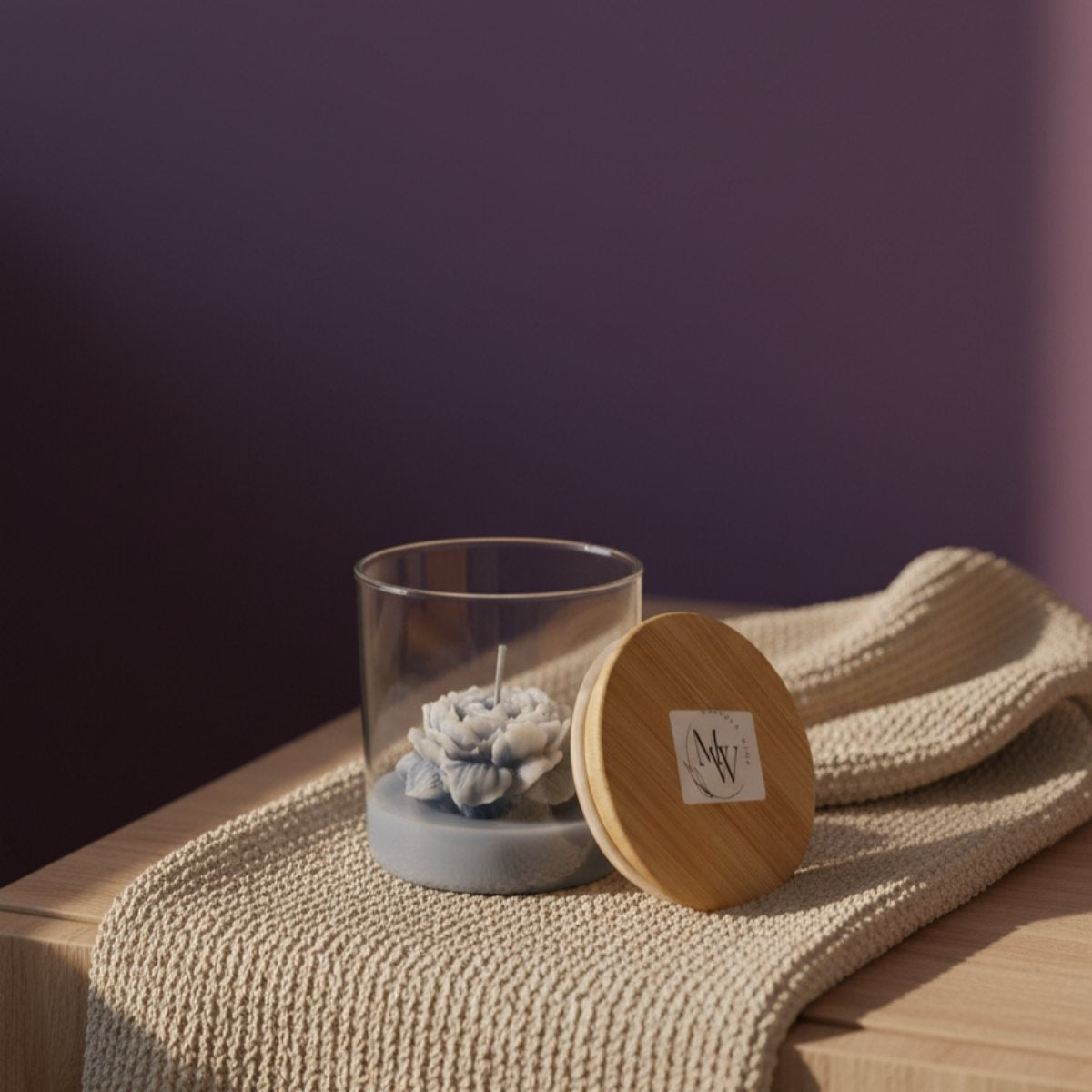 Ocean bloom hand-poured soy candle in ocean-inspired hues, featuring cashmere & caramel and black rose & oud scents