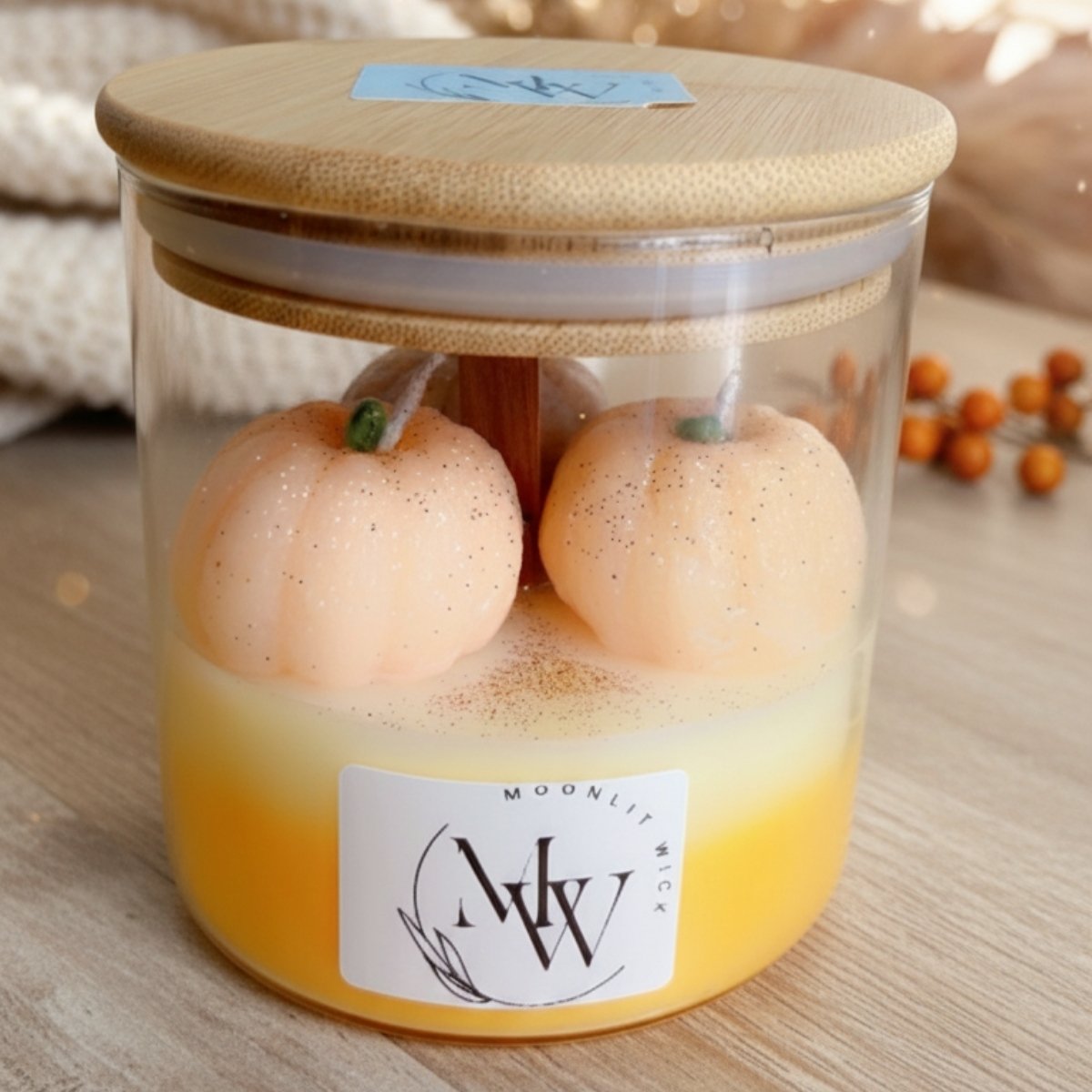 Autumn harvest pumpkin candle with lid on, multi-colored layers of yellow,white, and peach-brown